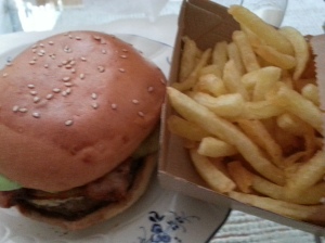 Bacon cheeseburger and fries in the now iconic bare cardboard box